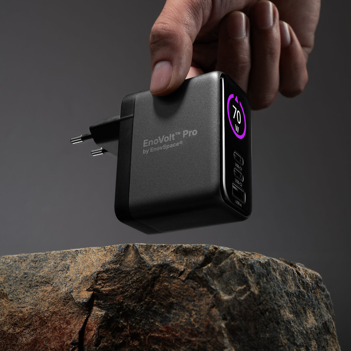 EnoVolt Pro 70W held in a hand, showing how compact the GaN charger is