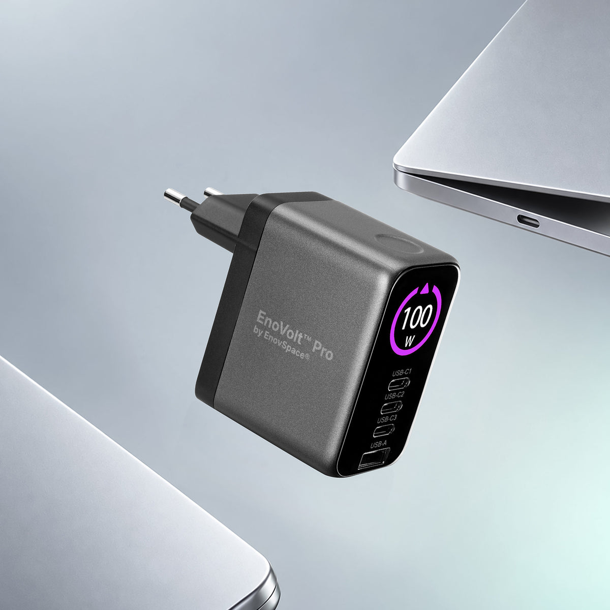 EnoVolt Pro 100W GaN charger next to a laptop on a desk