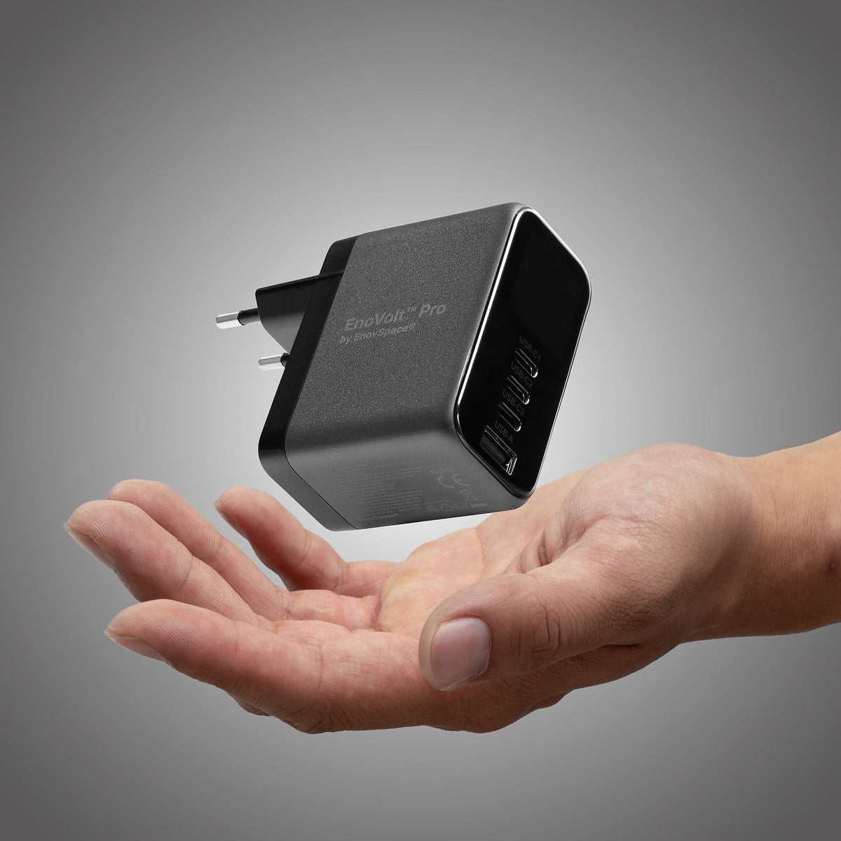 EnoVolt Pro 165W held in a hand, showing how compact the GaN charger is