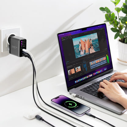 EnoVolt Pro 70W charging a laptop, a phone and earbuds at the same time on a desk
