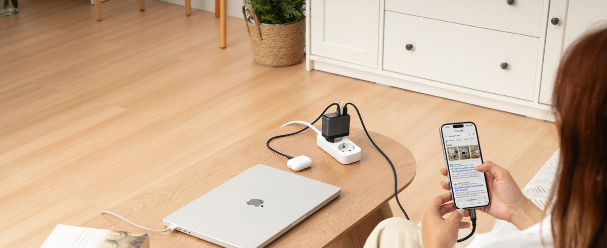 EnoVolt Pro 70W charging a laptop, a phone and earbuds from one power strip in a living room