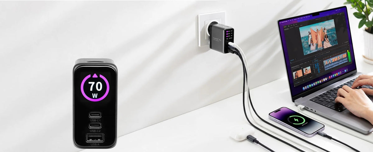 EnoVolt Pro 70W ports close-up: two USB-C and one USB-A, charging a laptop and a phone on a desk